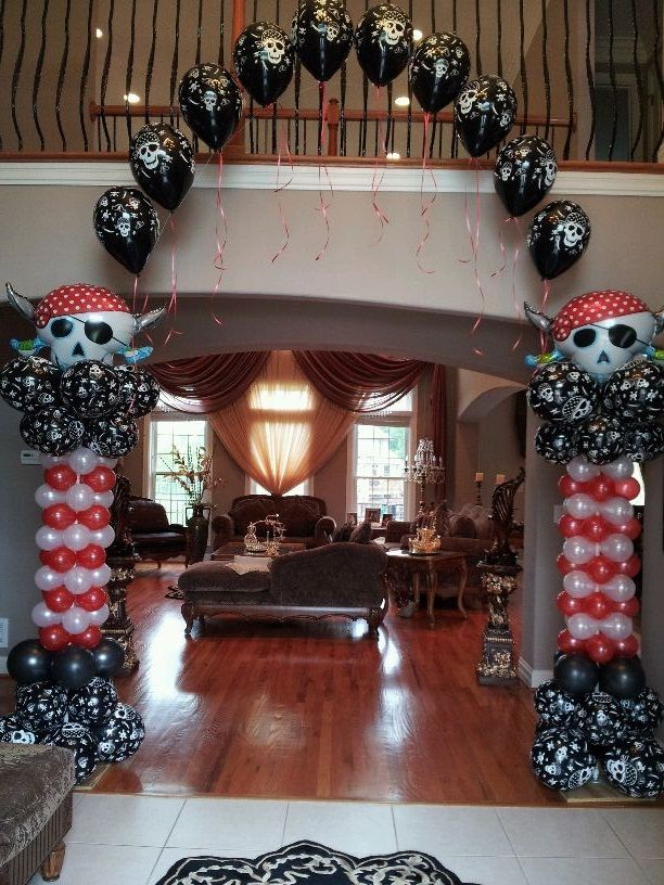 A living room decorated with balloons and a pirate theme