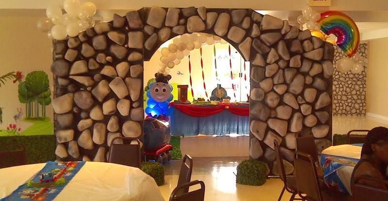 A room decorated for a birthday party with tables and chairs