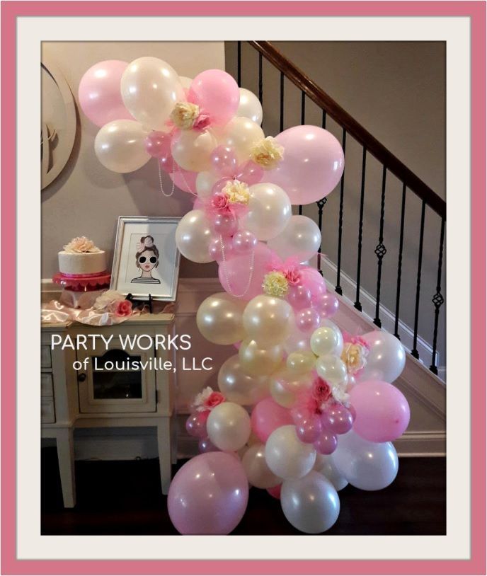 A bunch of pink and white balloons on a staircase by party works of louisville llc