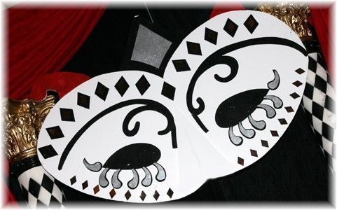 A black and white mask with diamonds and swirls on it