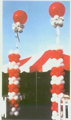 A bunch of red and white balloons stacked on top of each other