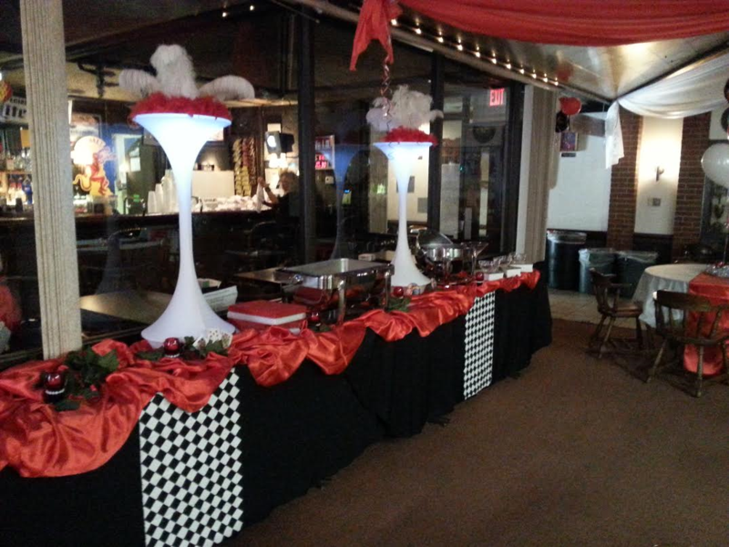 A buffet line in a restaurant with red and white decorations