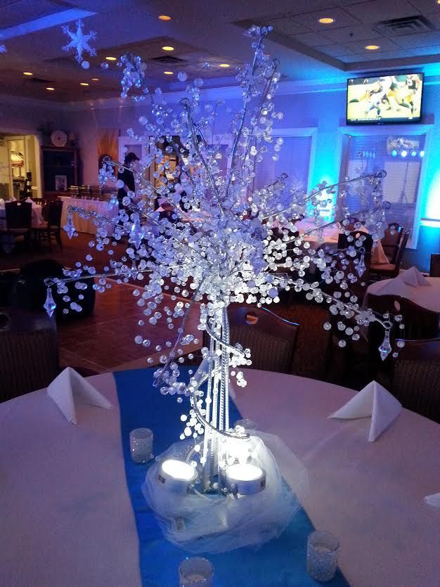 A table with a vase of snowflakes on it