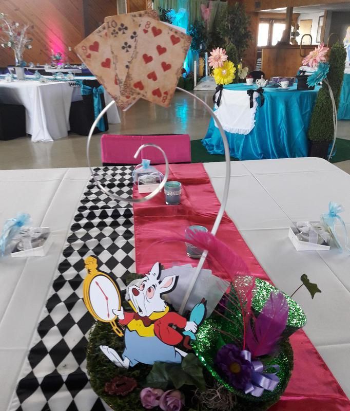 A table with a white rabbit and playing cards on it