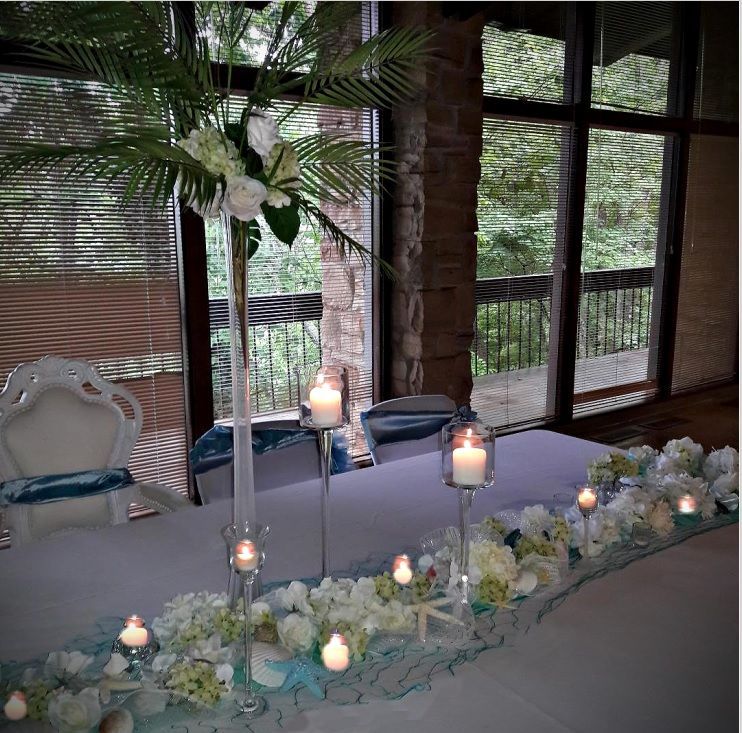A long table with candles and flowers on it
