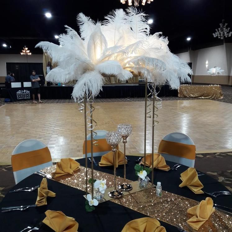 A table with feathers and candles on it