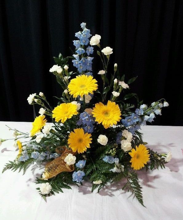 A bouquet of yellow and blue flowers on a table