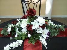 A table with flowers on it and a chair in the background.