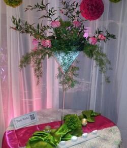 A martini glass filled with flowers is sitting on a table.