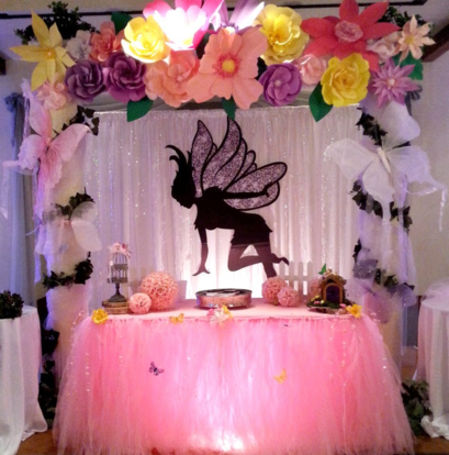 A pink table with a fairy on top of it