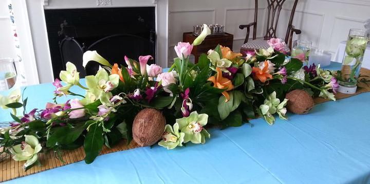 A table with flowers and coconuts on it