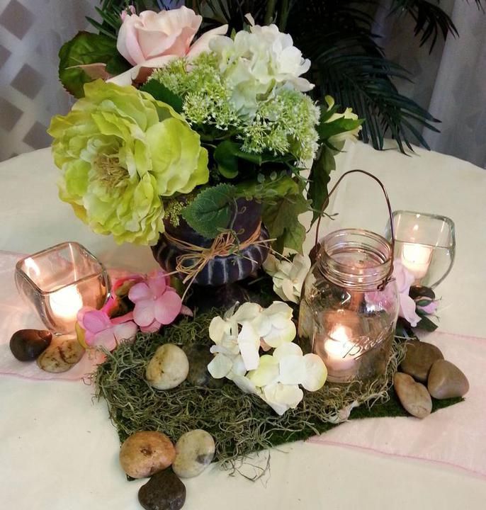 A table with flowers and candles on it