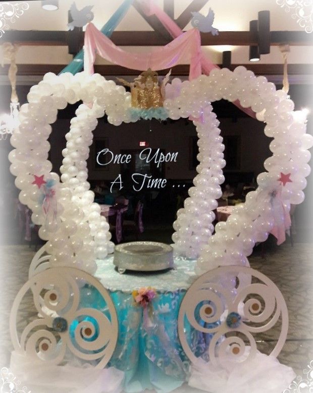 A carriage made of balloons with the words once upon a time written on it