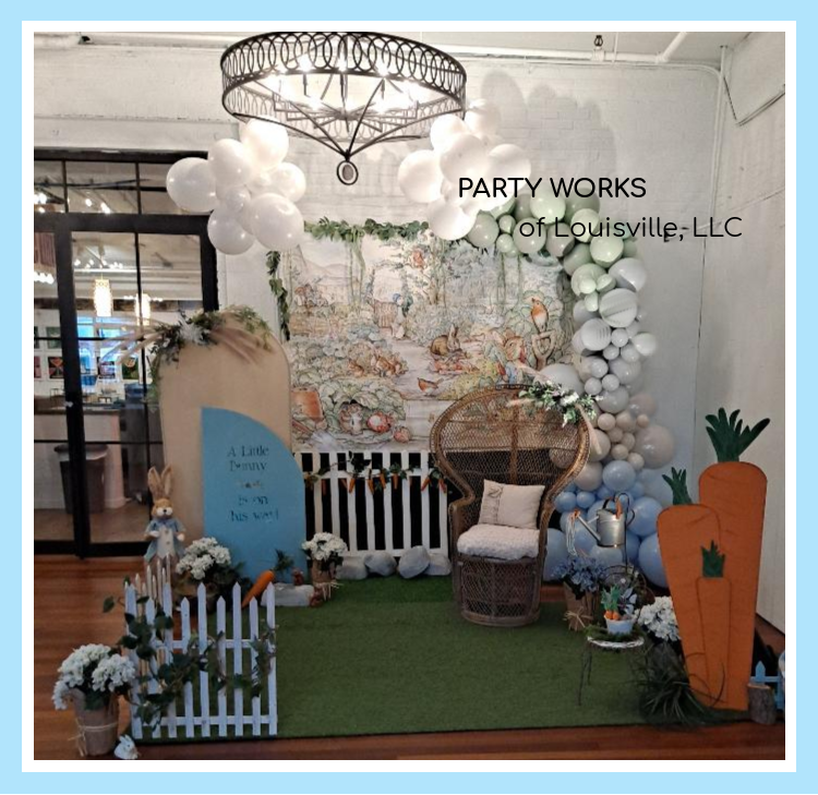 A room decorated with balloons and flowers by party works