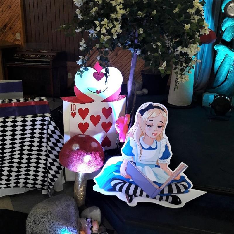 A cut out of alice in wonderland reading a book