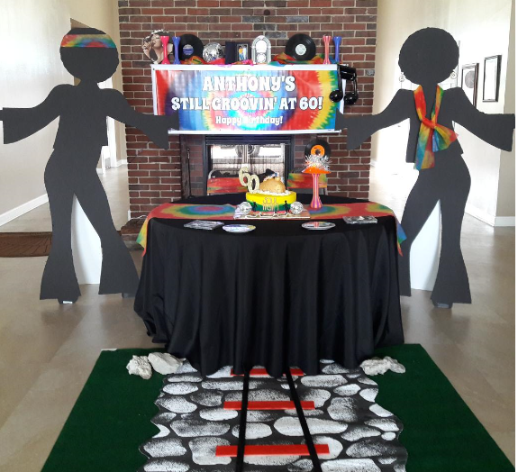 A table with a sign that says anthony 's still groovy at 50