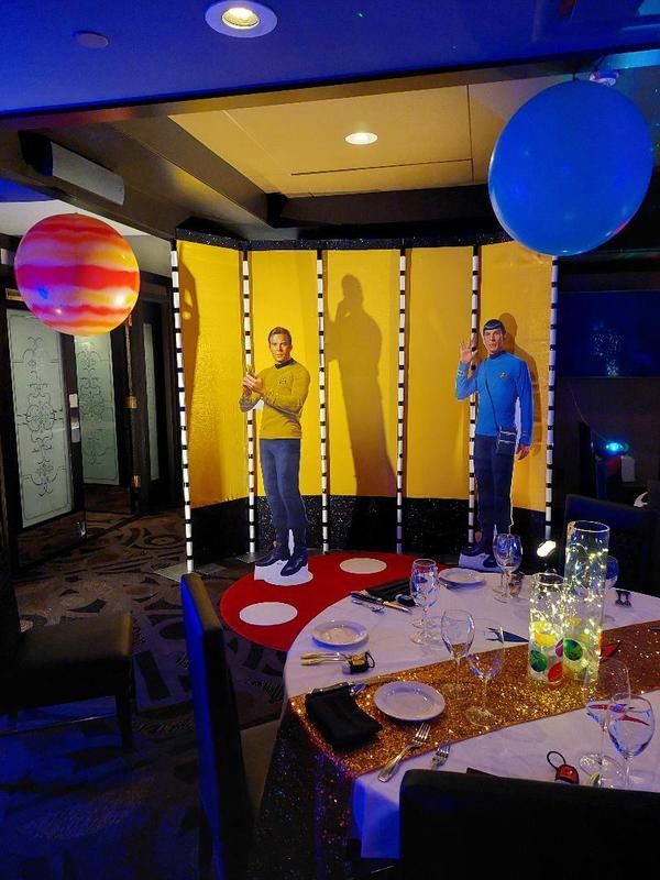 A room with a table with plates and glasses on it