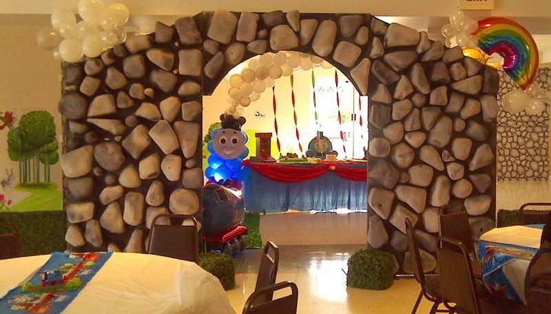 A room decorated for a birthday party with tables and chairs