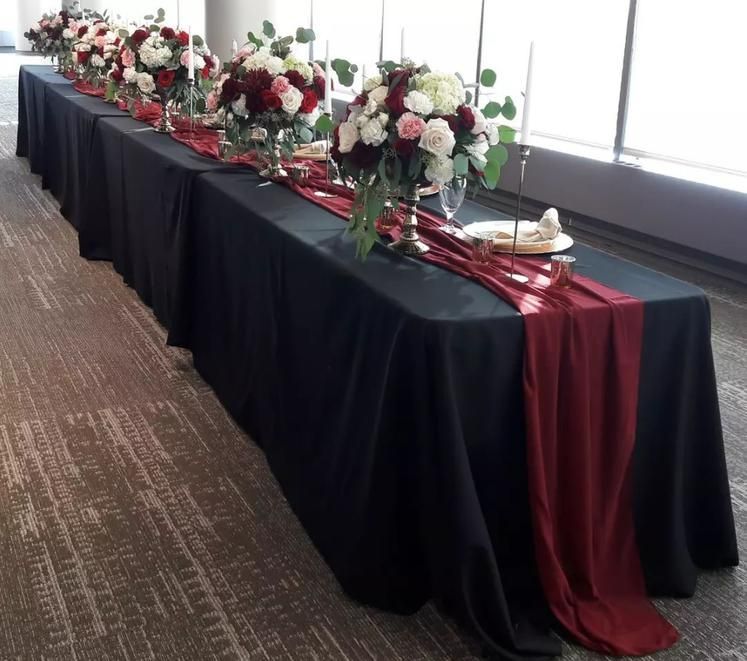 A long table with flowers and candles on it