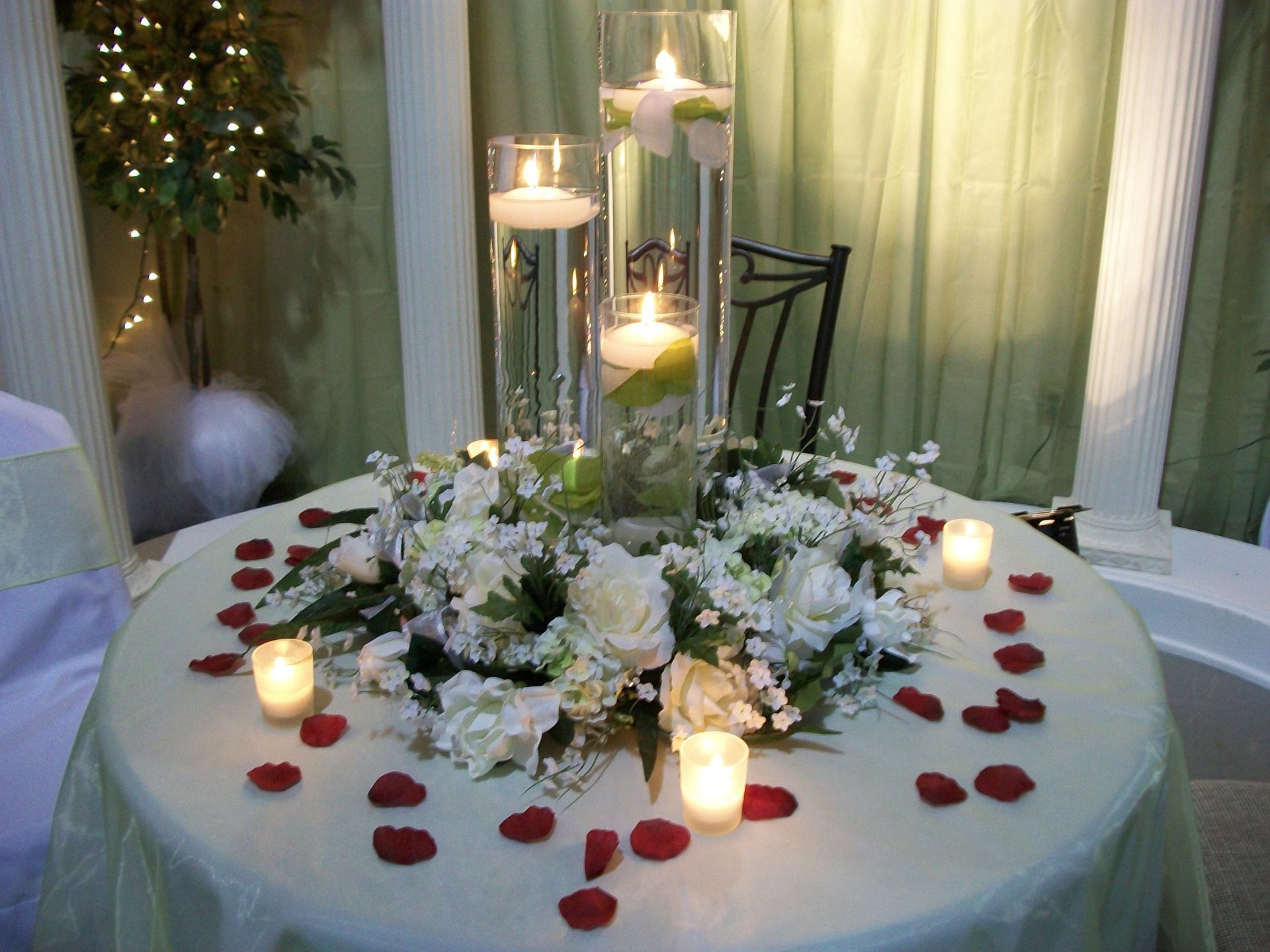 A table with flowers and candles on it