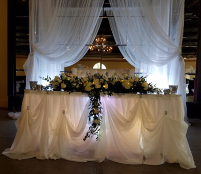 A long white table with flowers on it
