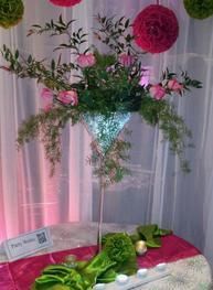 A martini glass filled with flowers is sitting on a table.