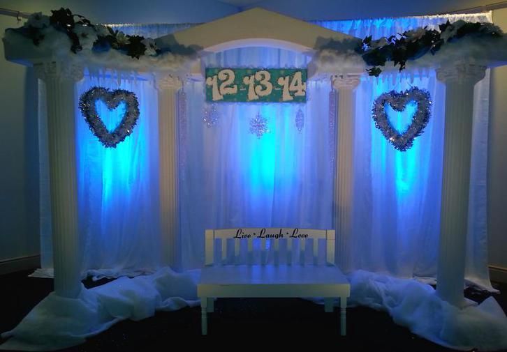 A room decorated for a wedding with blue lights and hearts