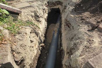 Installing sewer pipe in the ground trench