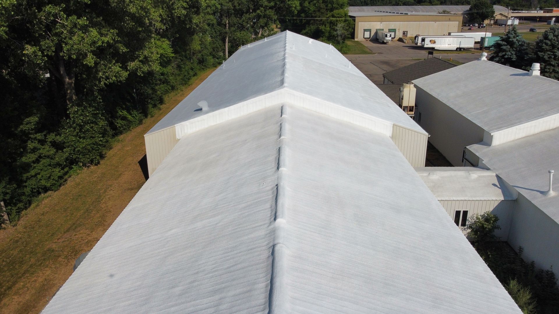 An aerial view of a bright, white metal roof on a building.