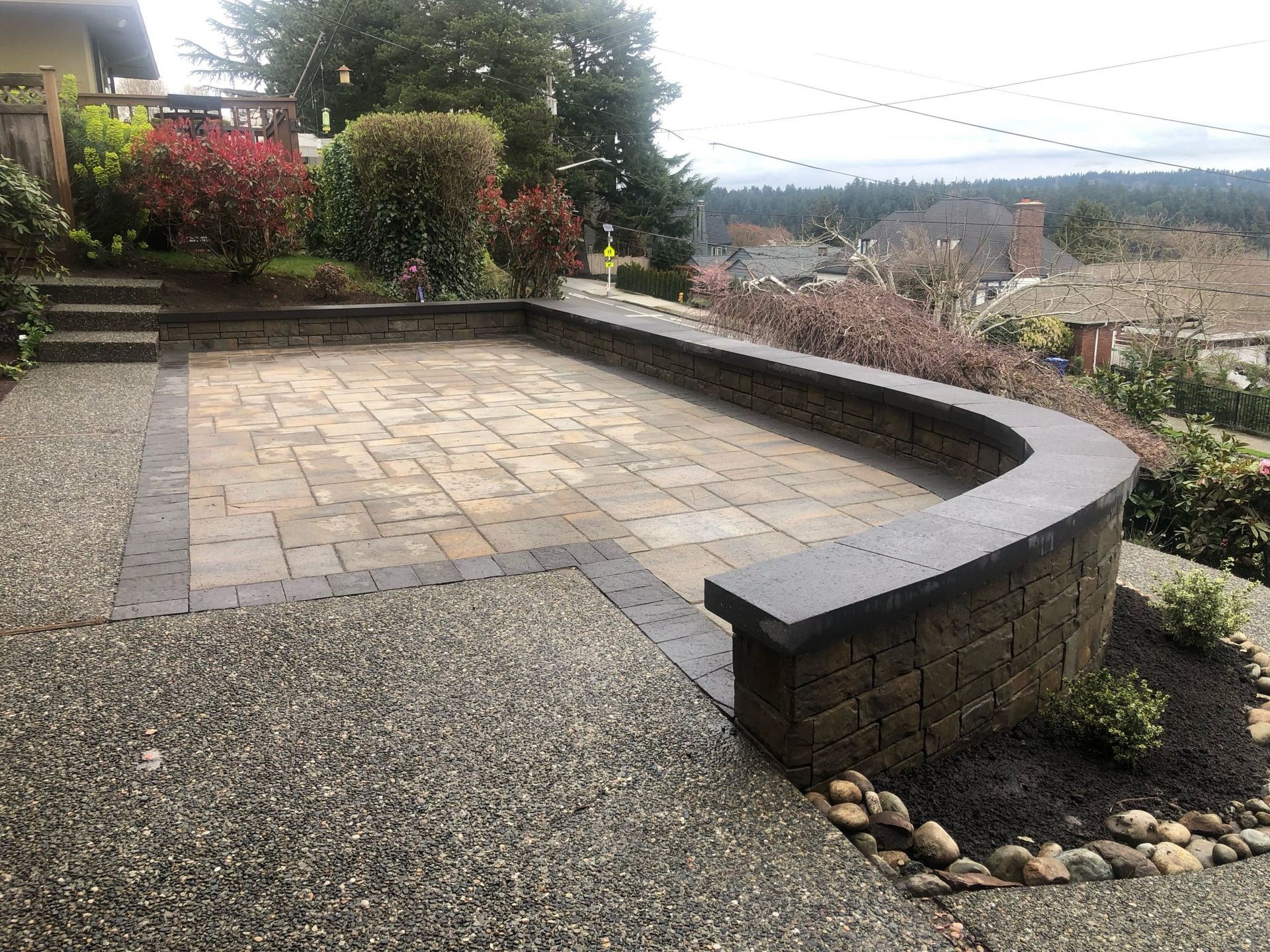 A brick patio with a bench and stairs in front of a house in Moroe, WA.
