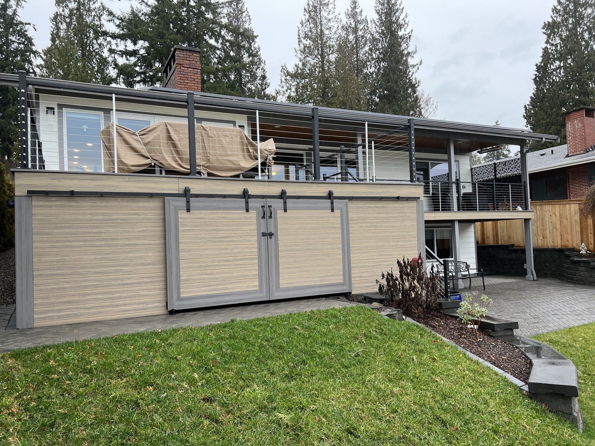 A house with a sliding barn door on the side of it.