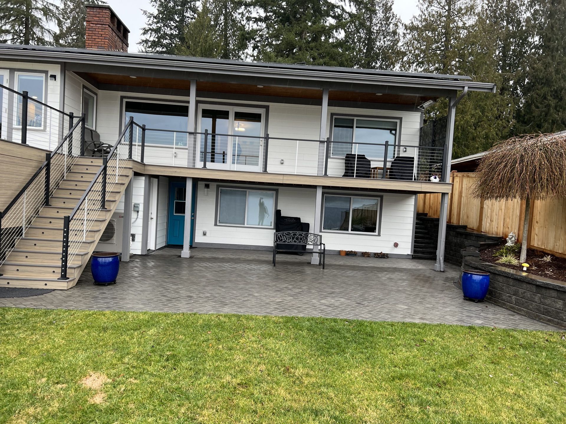 A large white house with a large lawn in front of it in Monroe, WA.