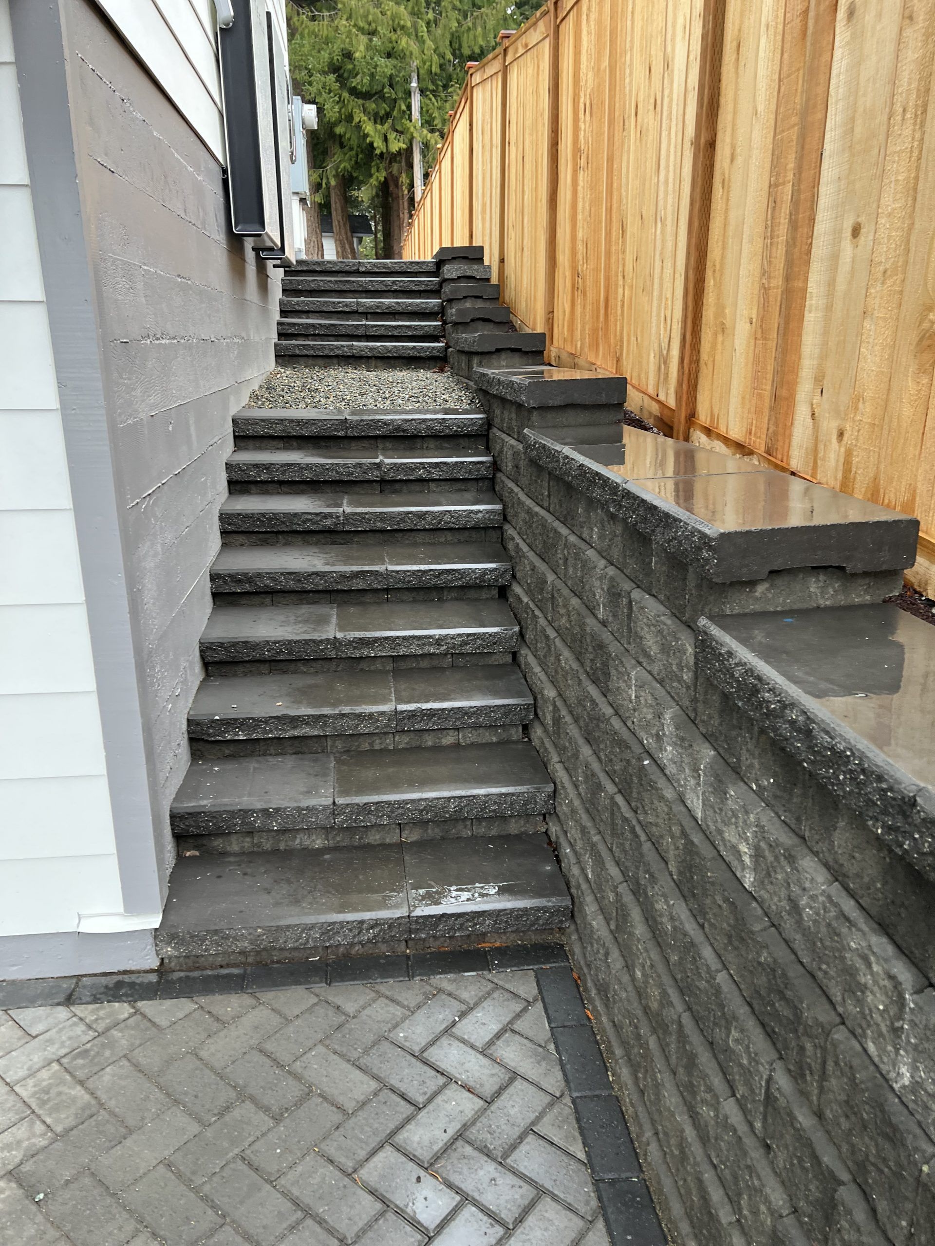 A set of stairs leading up to a wooden fence.