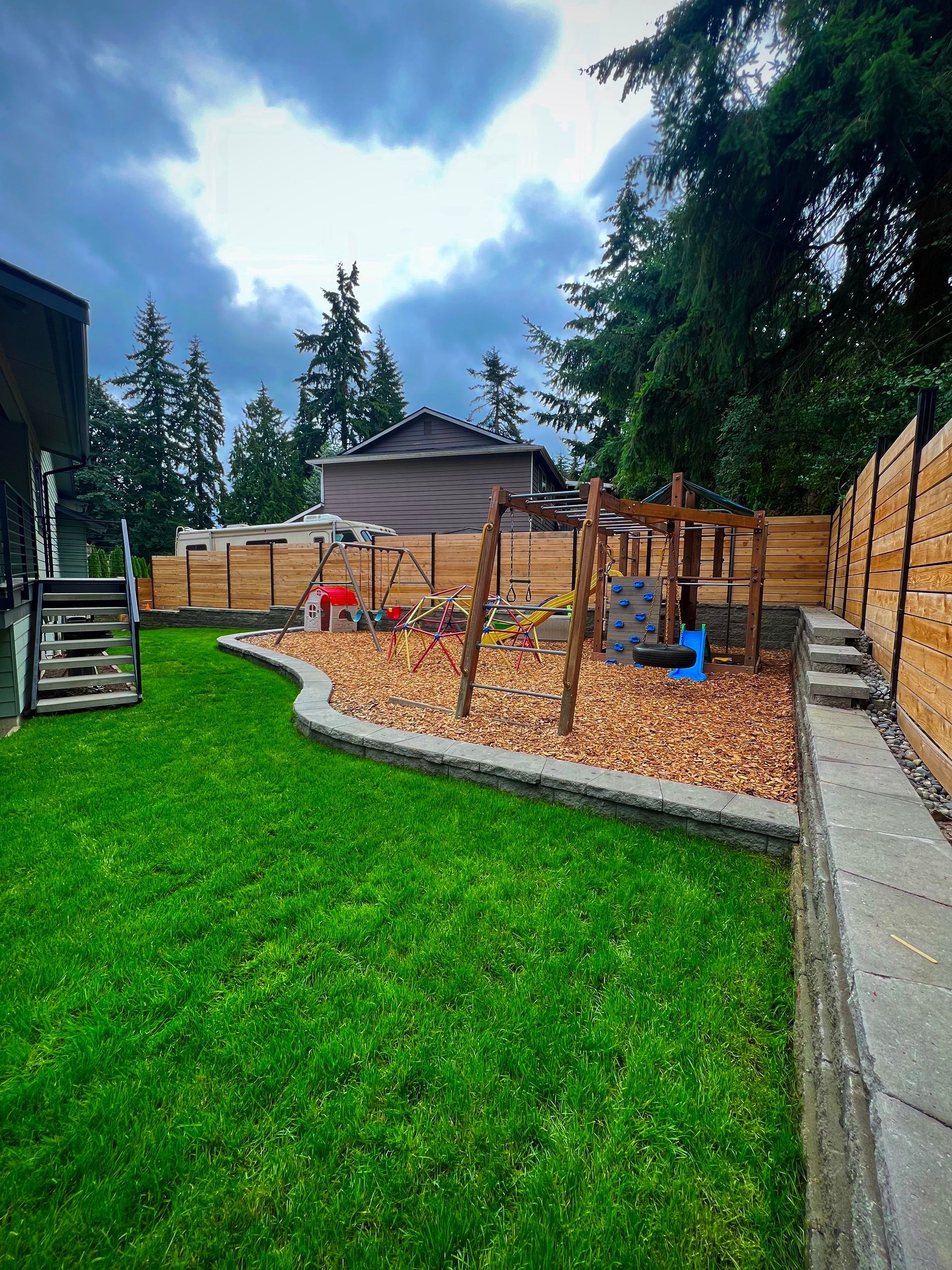 A patio in front of a house with steps and a grill cover in Monroe, WA.