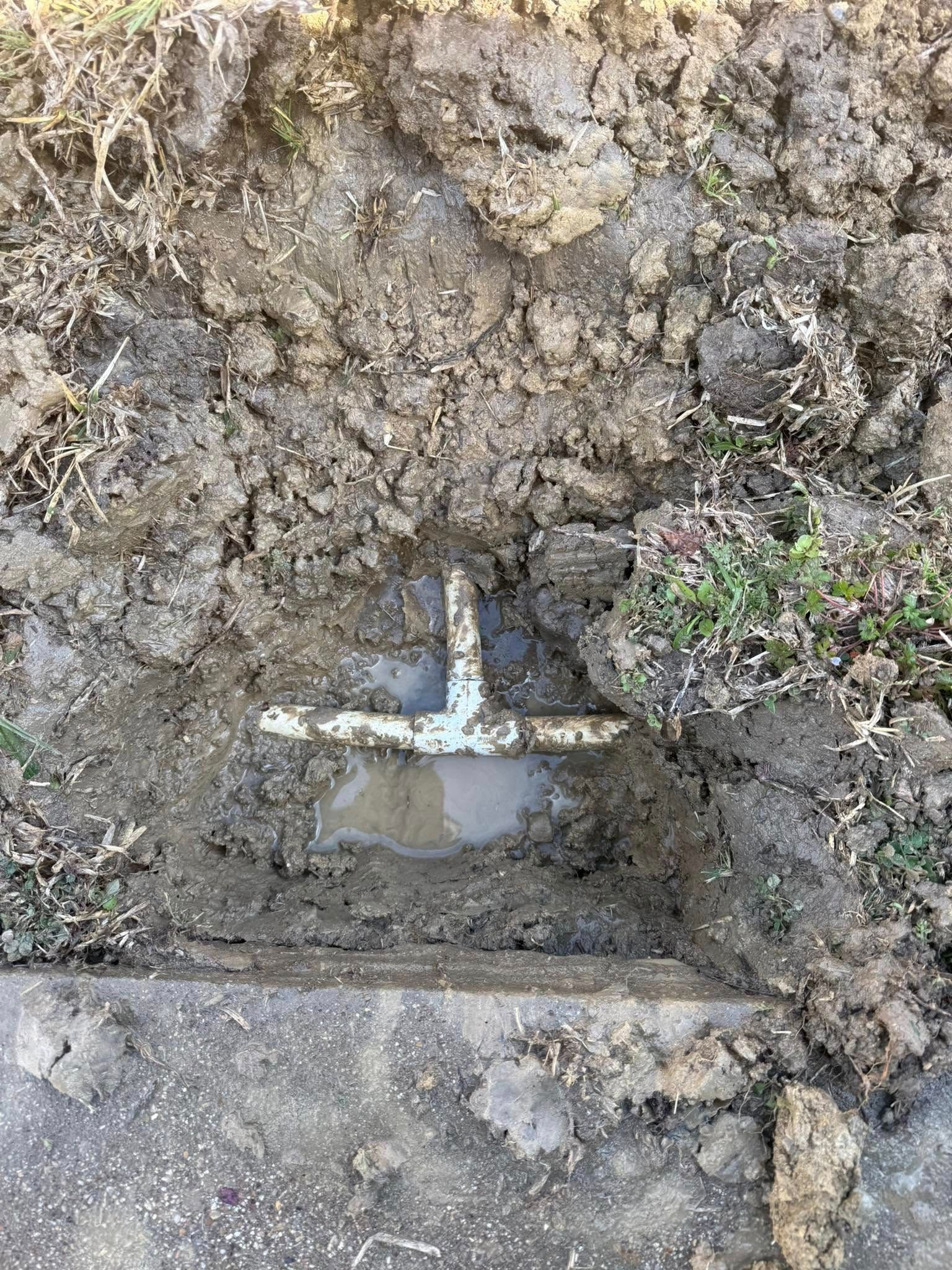 A wooden fence is sitting on top of a lush green field.
