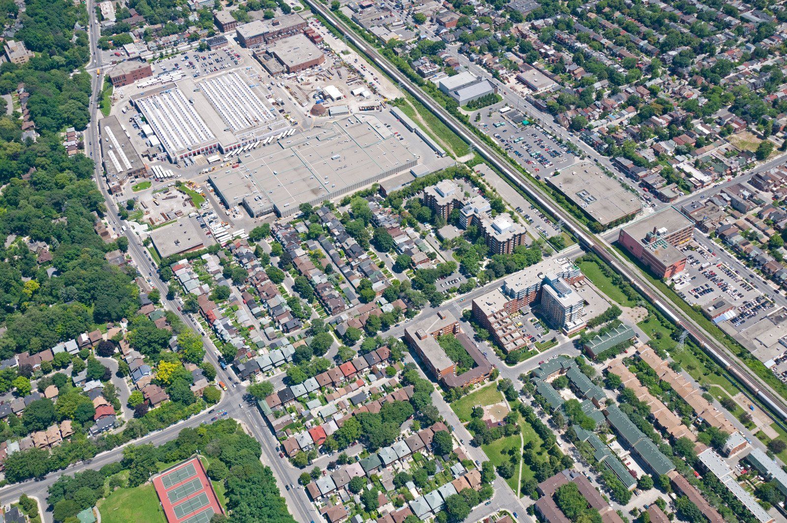 A wooden fence is sitting on top of a lush green field.