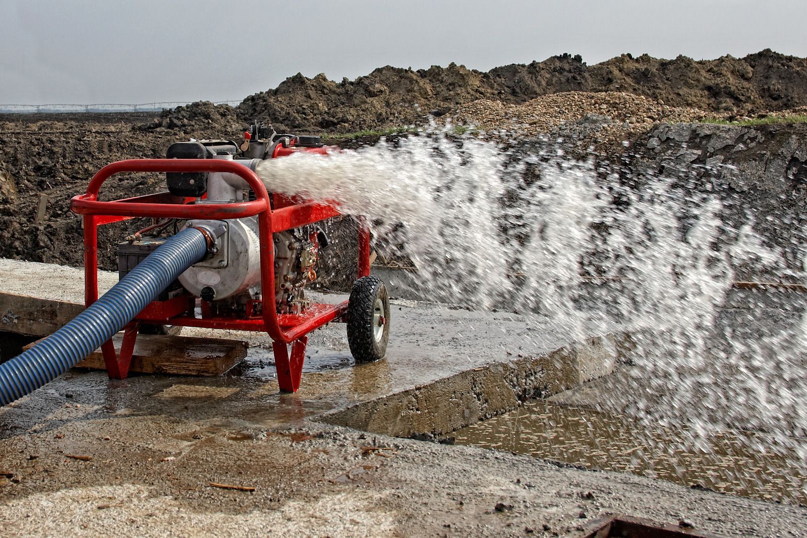 A wooden fence is sitting on top of a lush green field.
