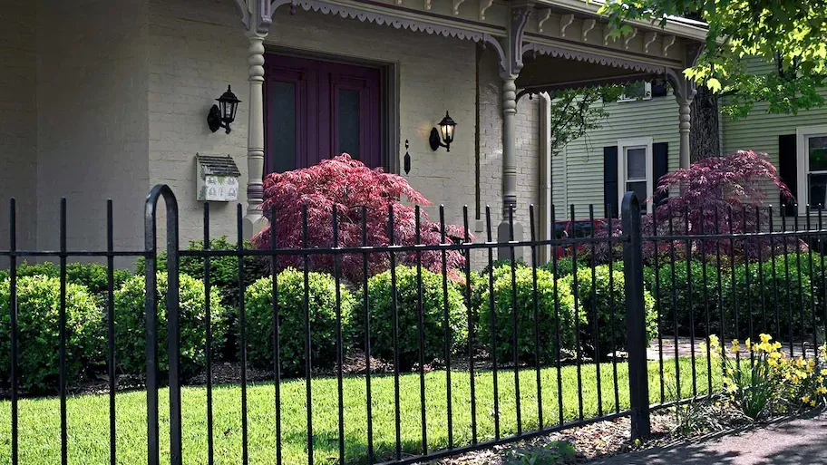 A close up of a brown fence in front of a house.