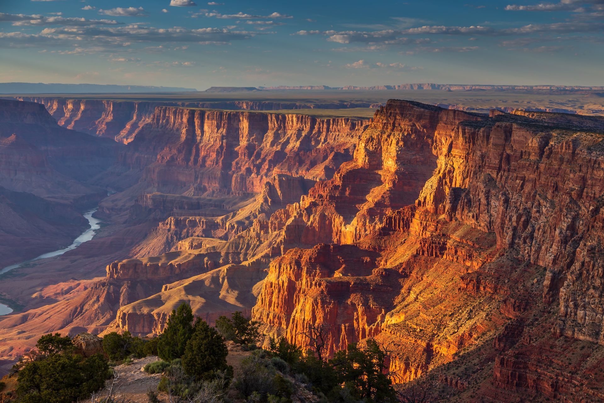 An aerial view of the grand canyon with a river running through it.