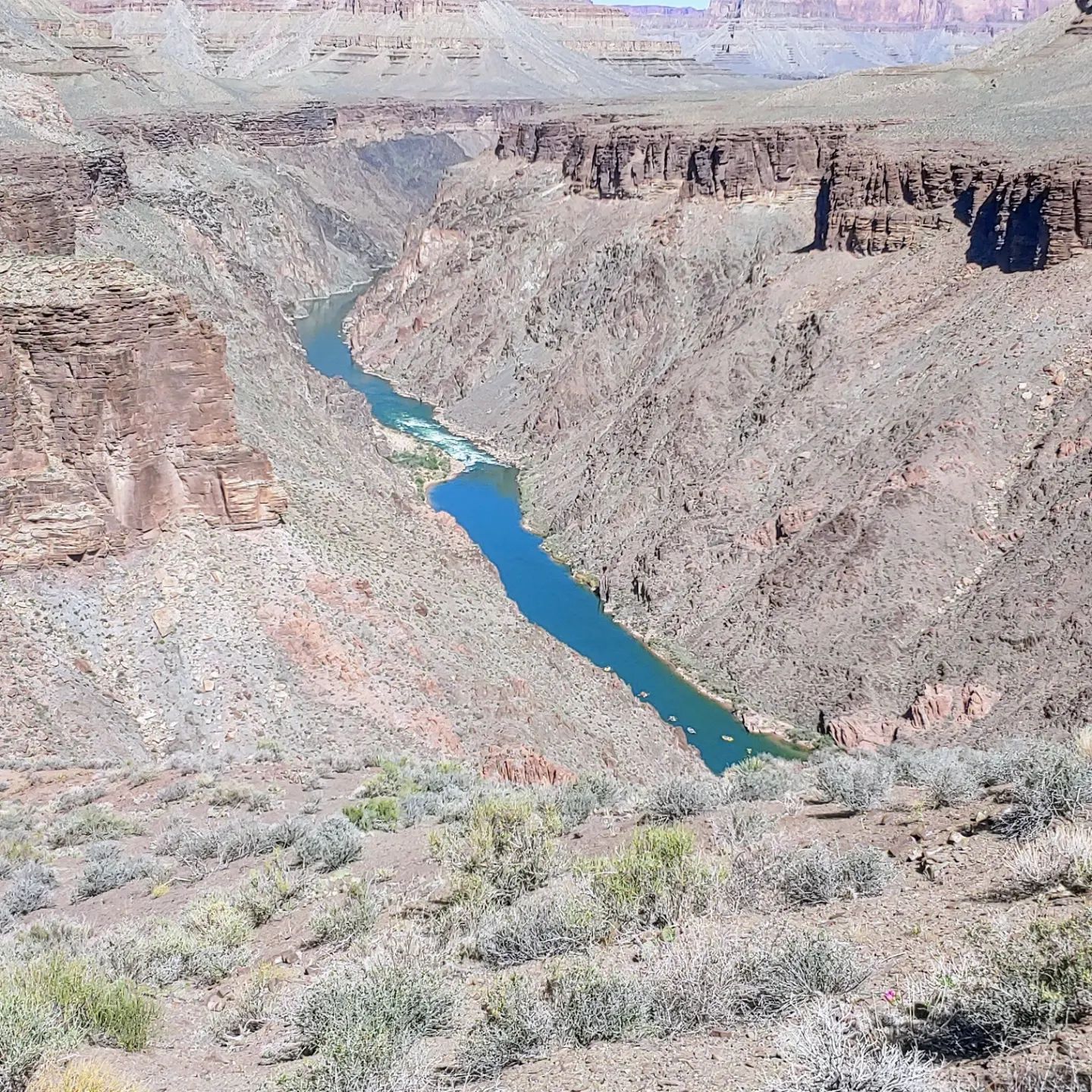 A river runs through a canyon in the desert