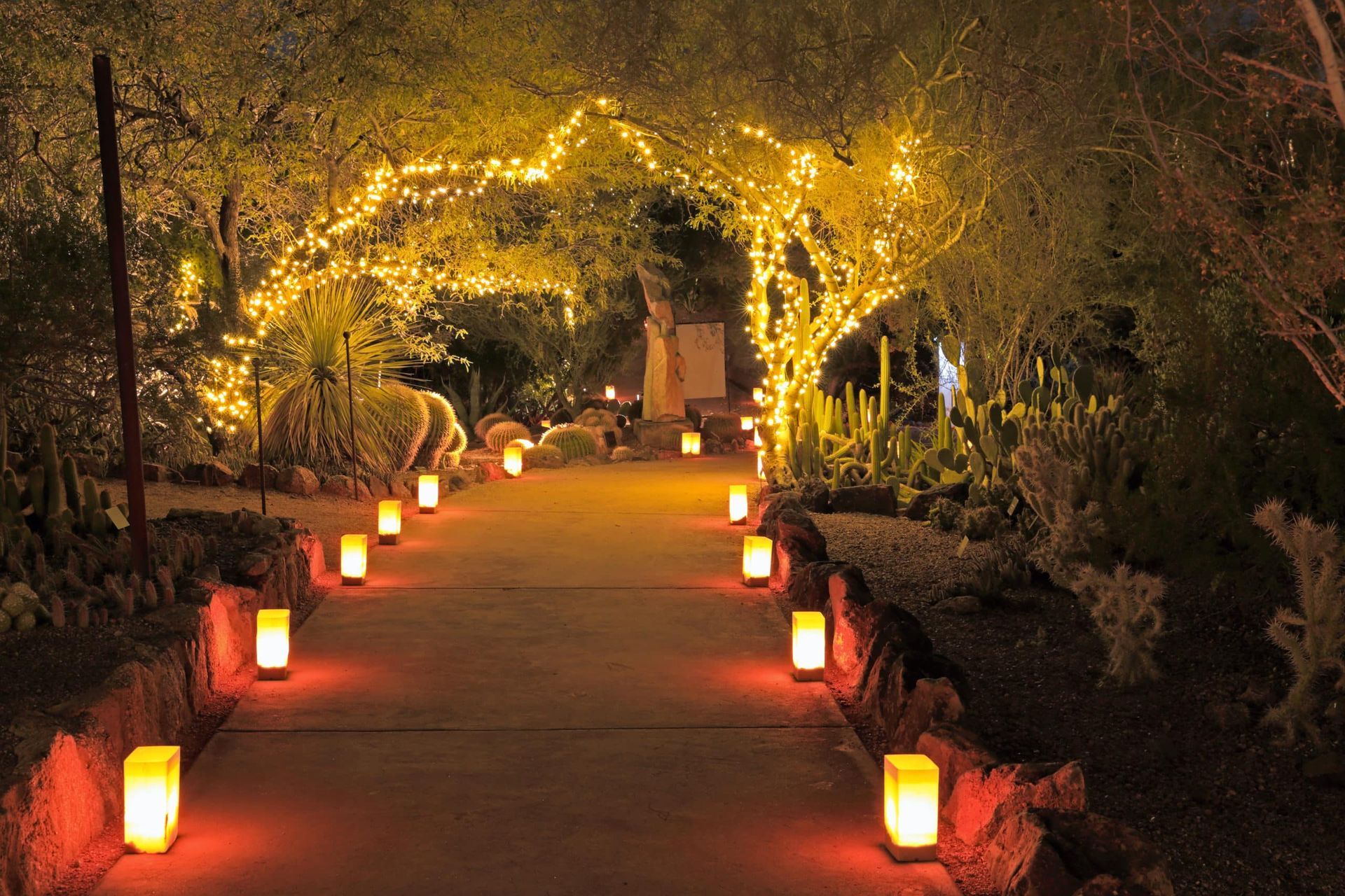 A path lined with candles and lights at night