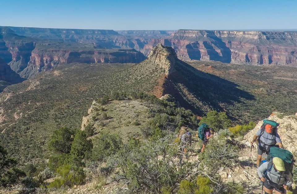 A group of people are hiking up a mountain.