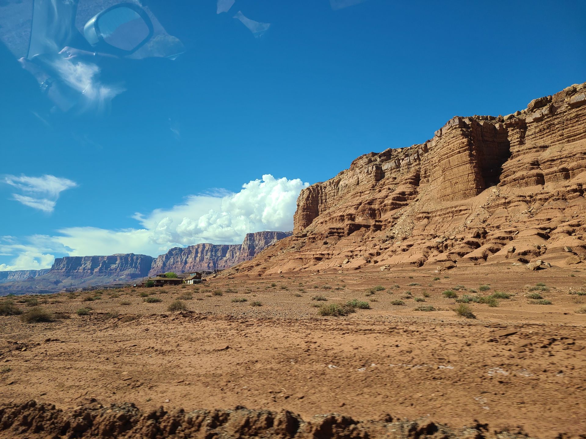 A desert landscape with mountains in the background and a blue sky
