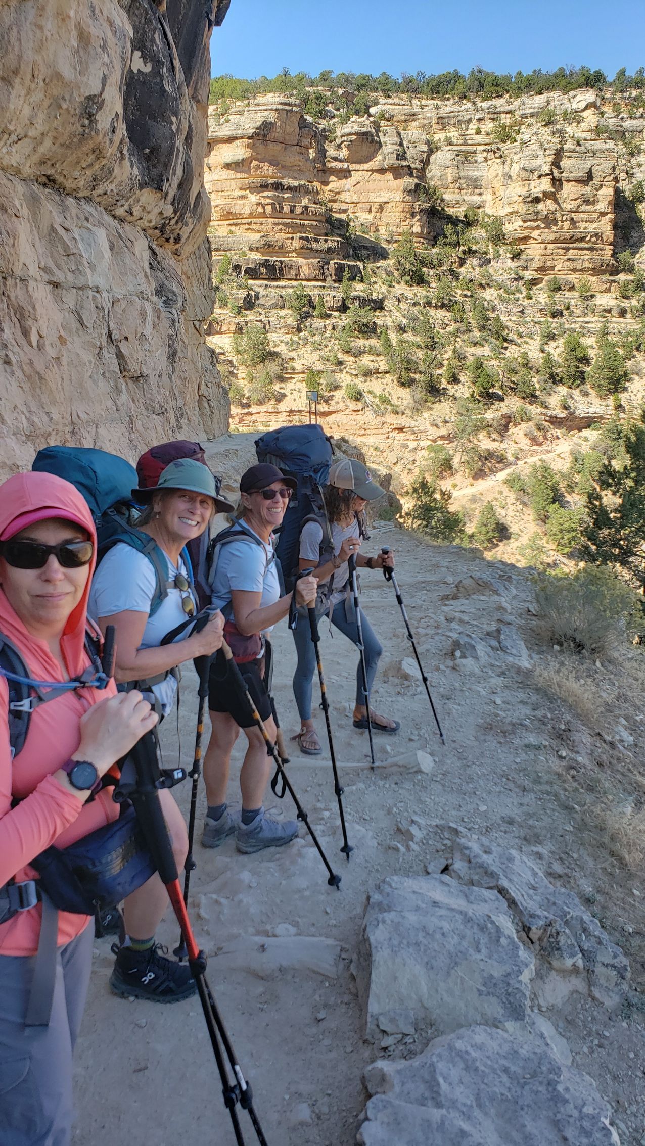A group of people are standing next to each other on a trail.