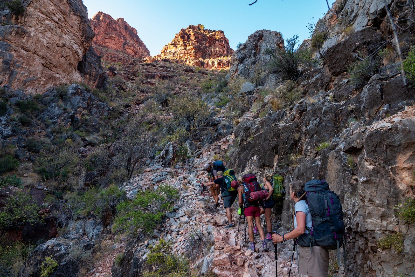 A group of people are hiking up a mountain.