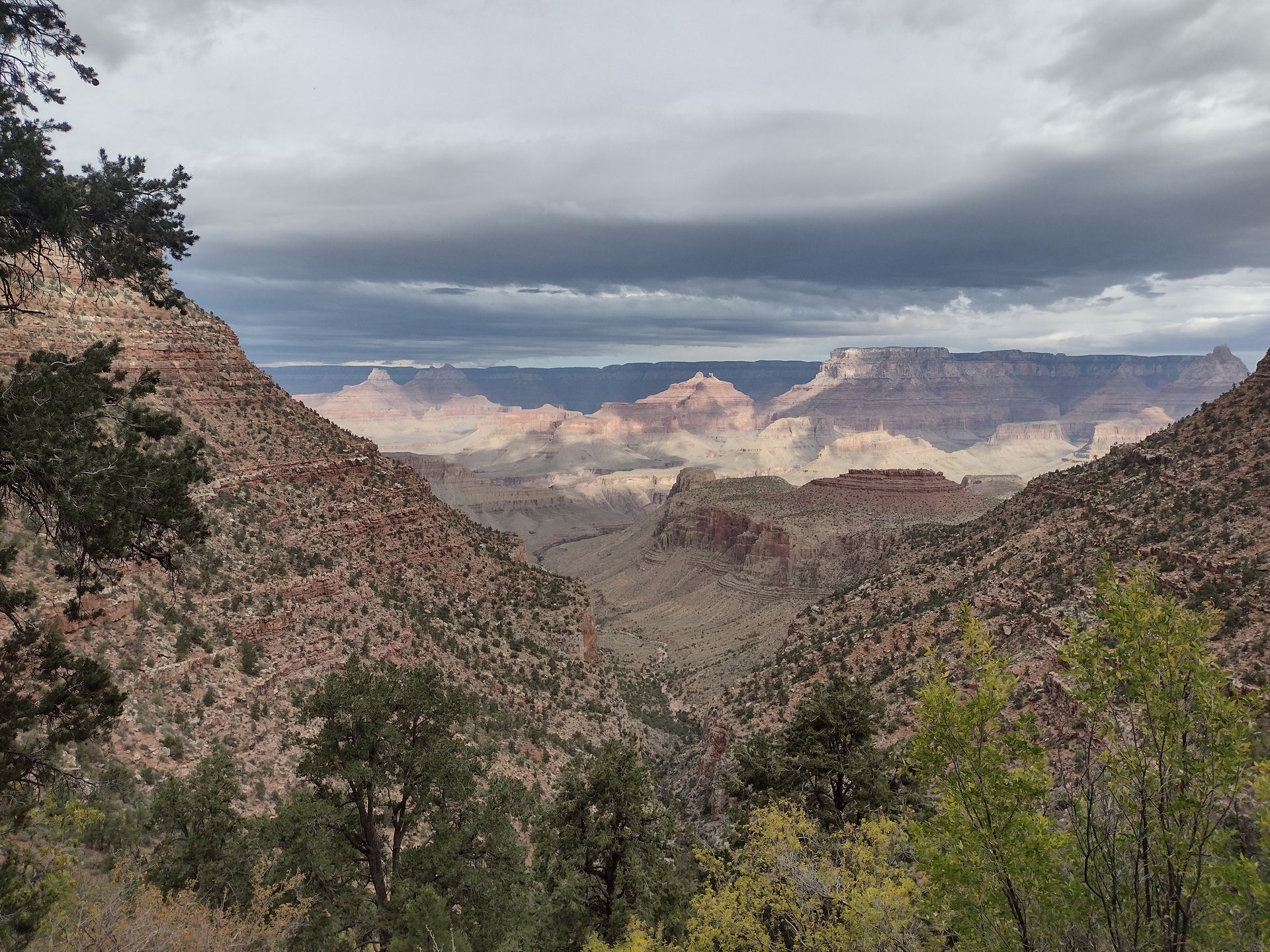 A view of a canyon with mountains in the background