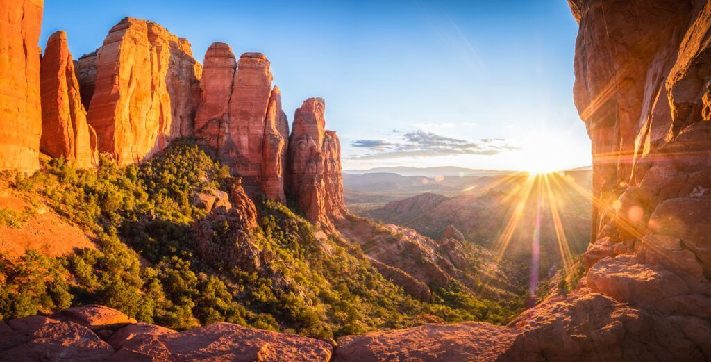 The sun is shining through the rocks in the mountains.