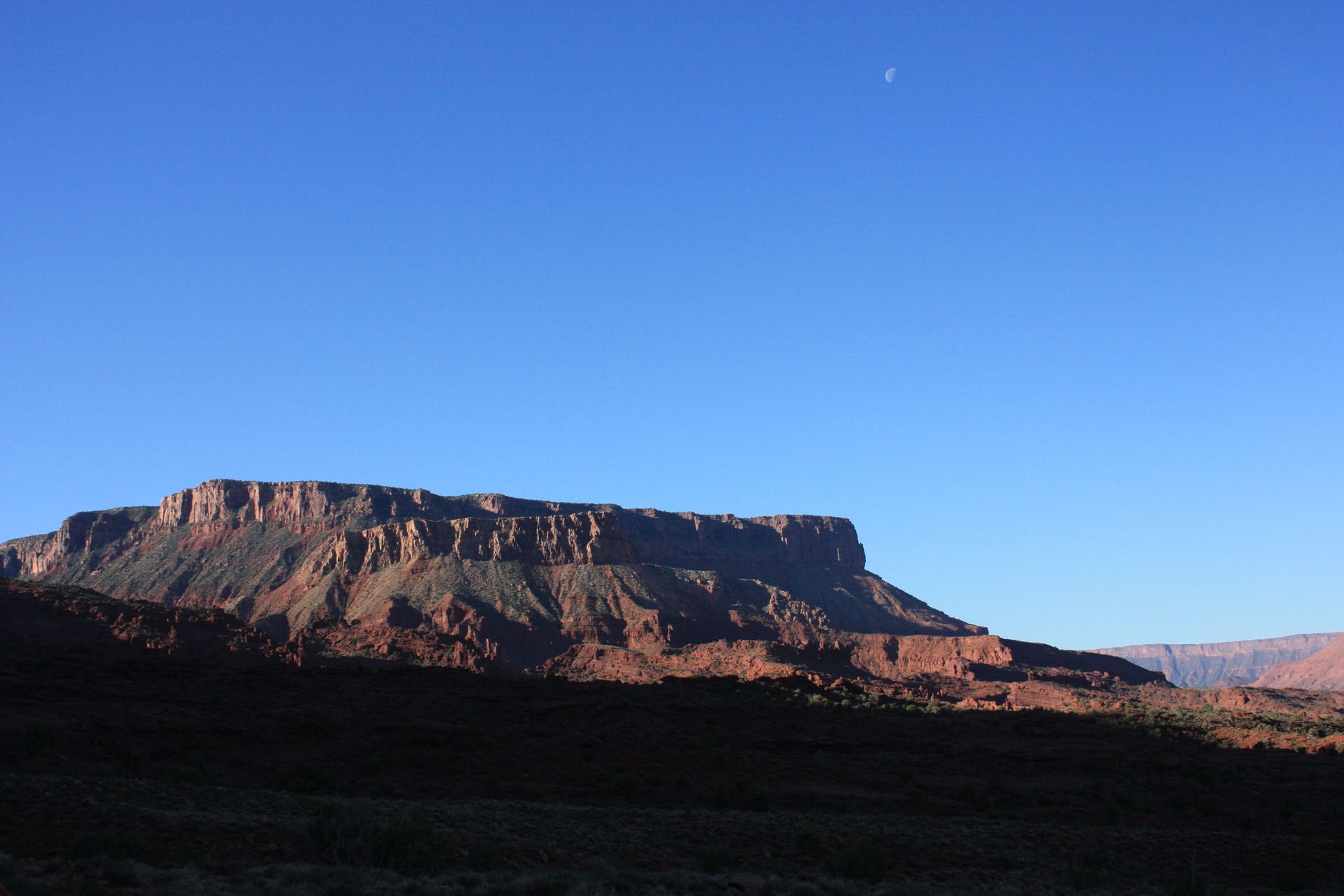 A mountain with a blue sky in the background