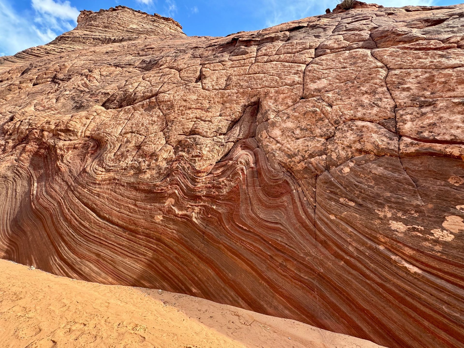 A close up of a rock formation with a blue sky in the background.