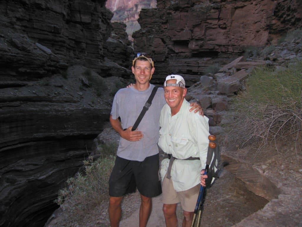 Two men standing next to each other with their arms around each other